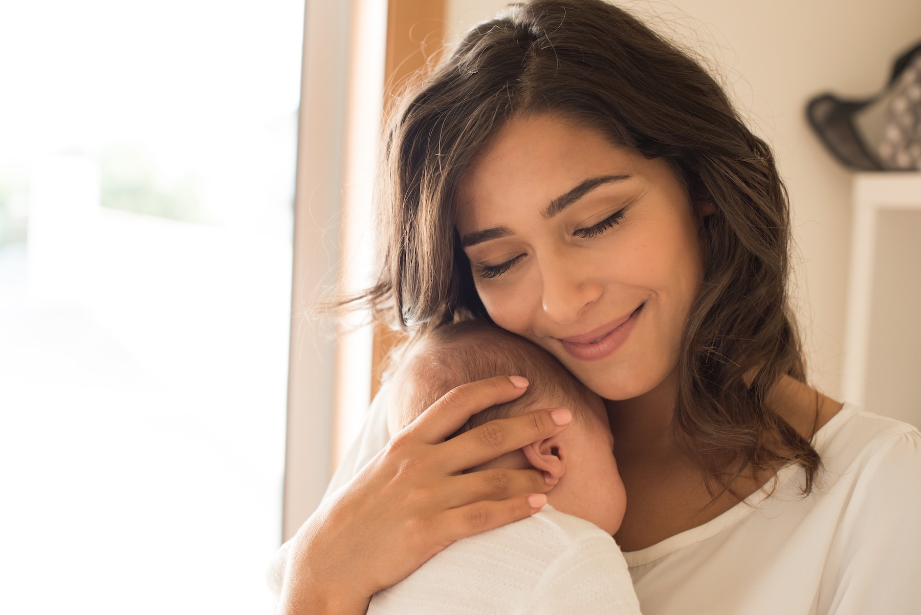 Adult holding a newborn baby gently